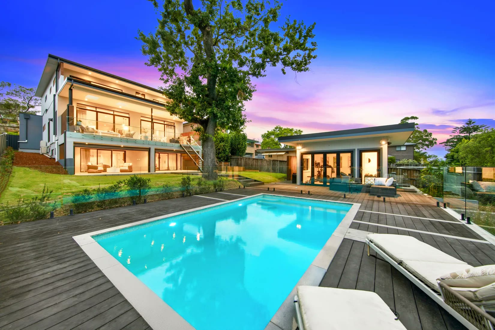 Facade and pool lit at dusk