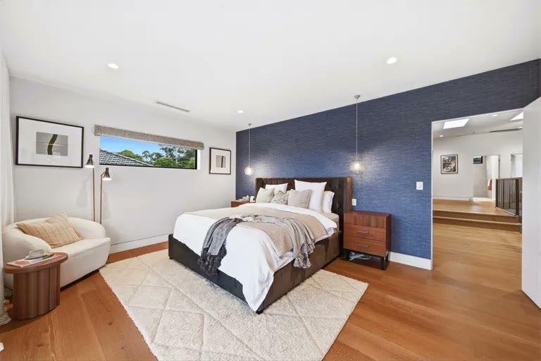Main bedroom with navy feature wall
